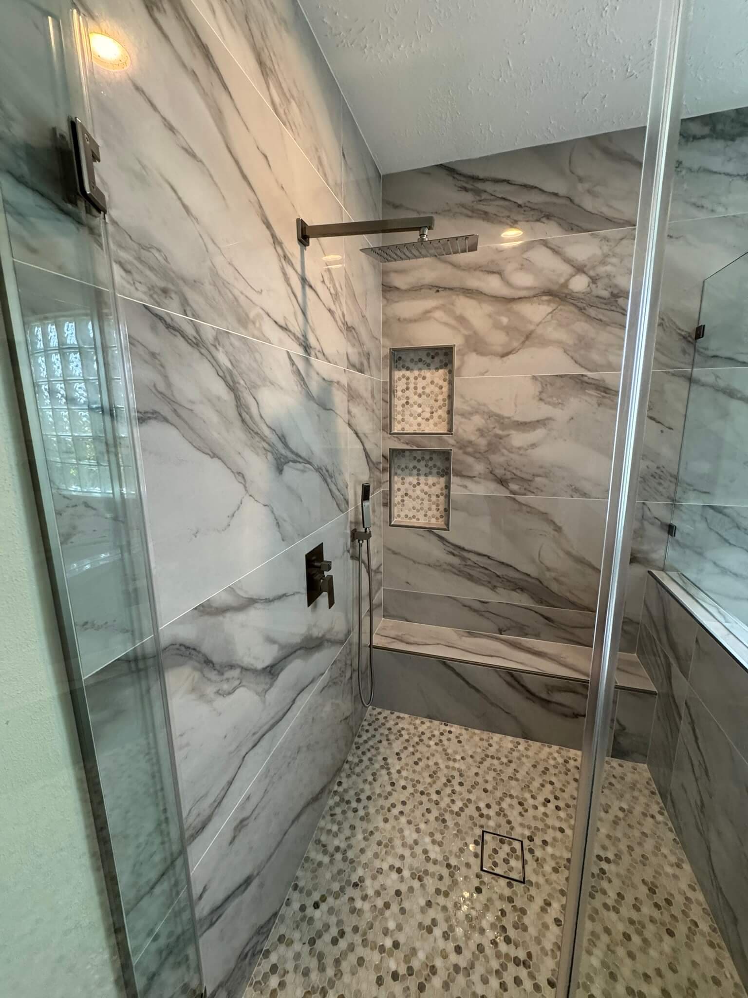 Bathroom remodel: pebble floor shower niches