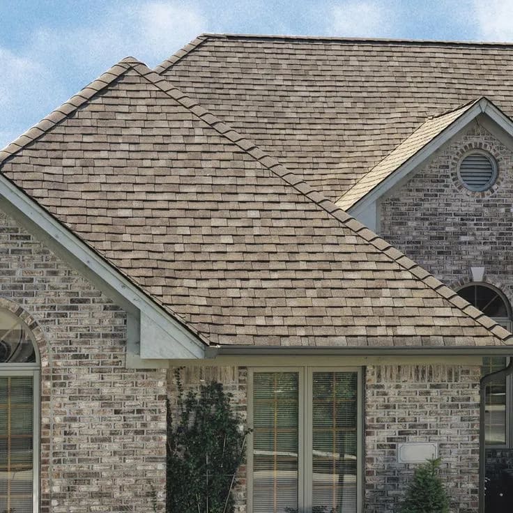 Brick home with multiple gables and a newly finished roof