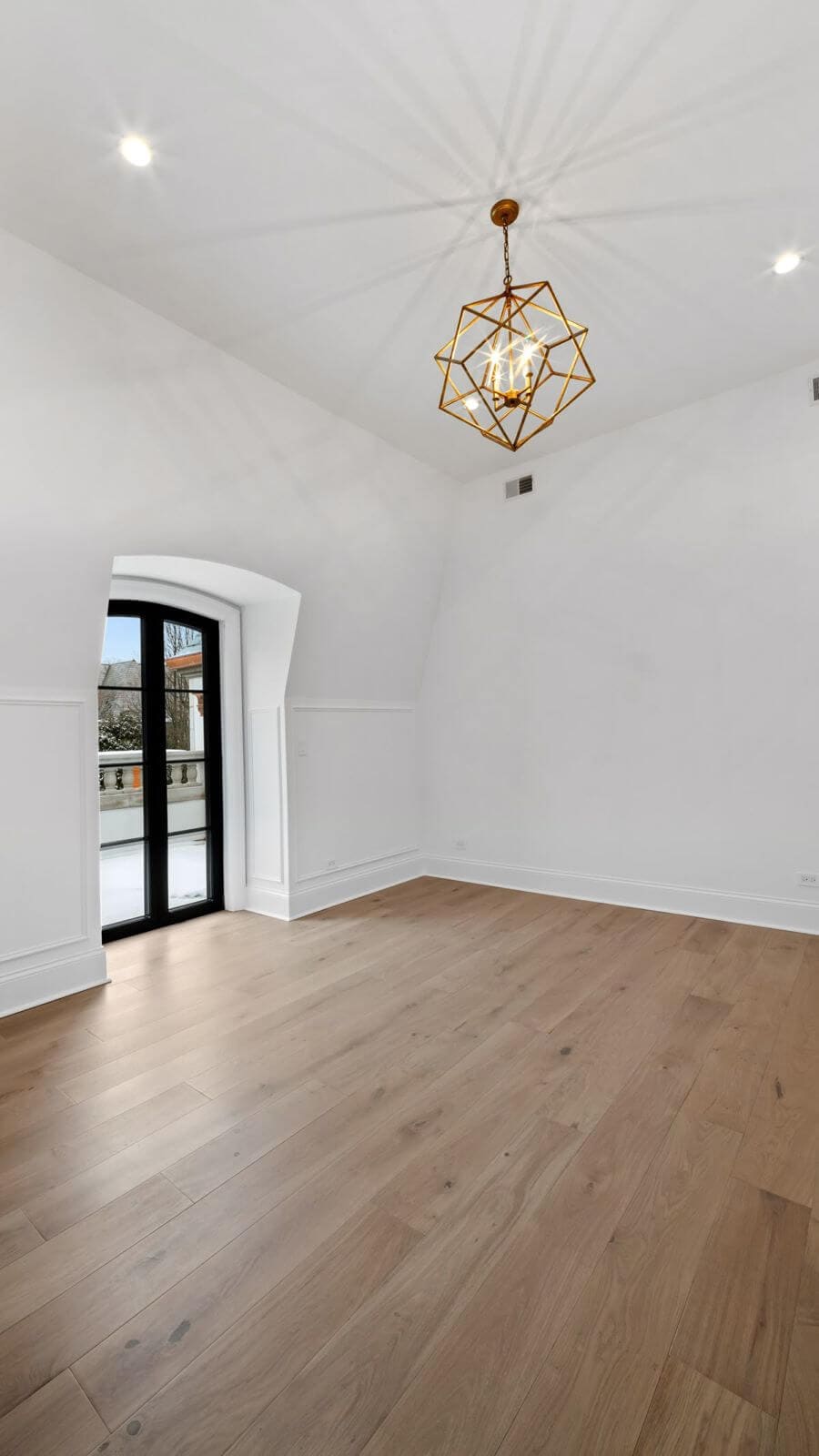 Light wood plank flooring in an empty, sunlit room